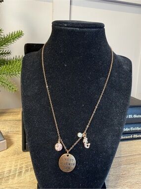 Gold tone charm necklace pendant stamped the phrase "I NEED VITAMIN SEA"